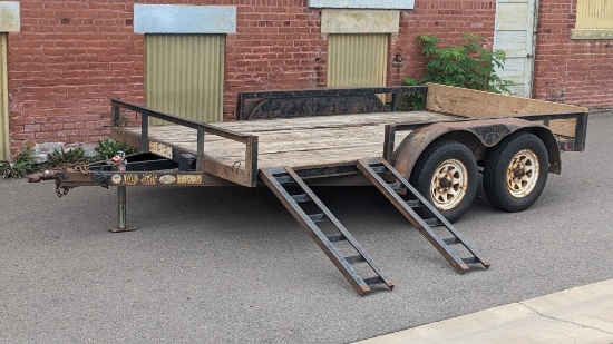 Load Trail 12' tandem axle trailer with electric brakes, double side-load cutouts, and ramps. Deck