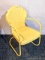 Neat yellow lawn chair is in good condition and about 20