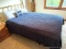 Clean queen sized bed with brass toned headboard. Brand not found on mattress, but it all looks in
