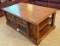 Beautiful coffee table has through-storage and measures 28
