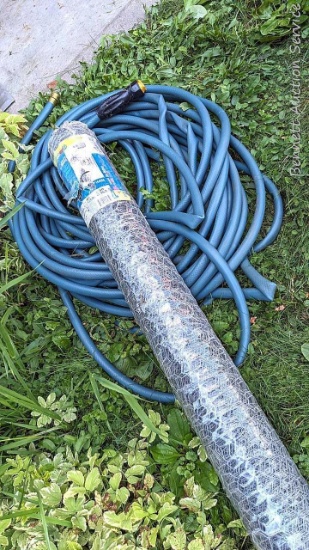 50' roll of 4' chicken wire is new in package. Plus a length of garden hose.