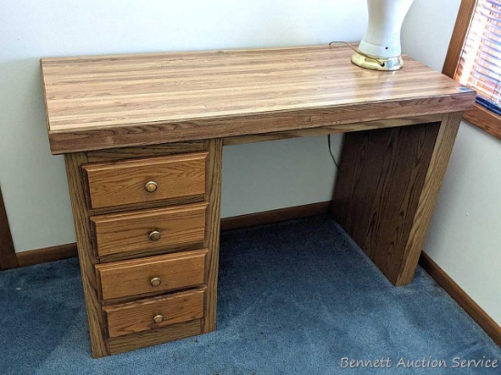 46" wide student's desk is in good condition and has four drawers for extra storage.