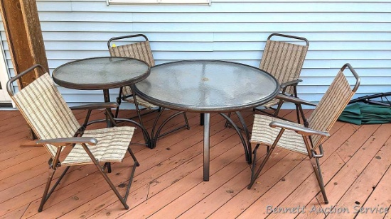 Patio set includes 4' diameter and 30" diameter glass topped tables, plus four folding chairs.