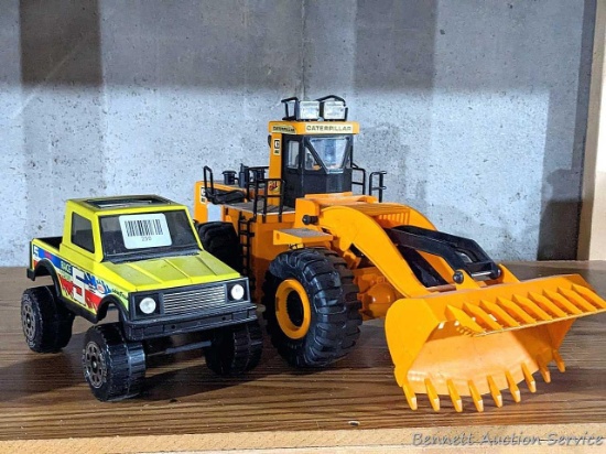 10" Tonka race truck and a 21" Caterpillar loader by New Bright. Both in pretty good condition.