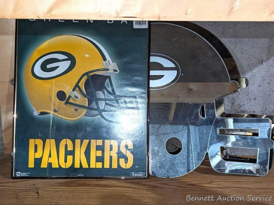Two 24" x 19" Green Bay Packers helmet mirrors and a 20" poster. Crack noted across faceguard of one