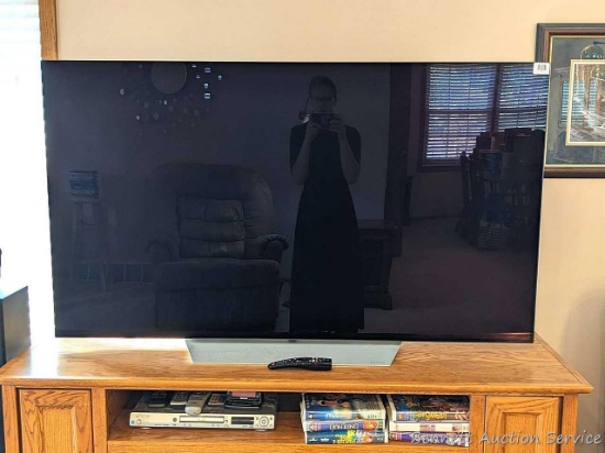 LG OLED 65" flat screen television with remote, Model OLED65C7P-U. TV powers up and has a clear