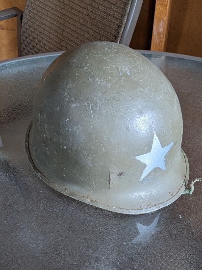 US military metal helmet with chin strap, but no liner.