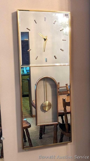 Vintage mirrored wall clock is approx. 3' tall x 15" wide and in good condition.