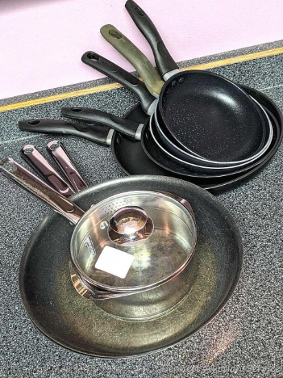 Three 12" skillets, four smaller and a nice little 1-1/2 quart WearEver saucepan with glass lid.