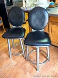 Two sturdy bar stools are both in very good condition and are of a more modern design. Upholstery is