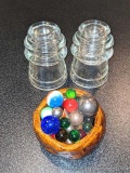 Two Hemingray glass insulators; cute little pottery dish holds a nice collection of marbles.