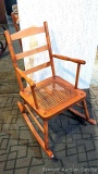 Nice little rocking chair has a caned seat and is in very nice condition.