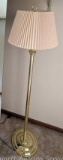 Brass toned floor lamp stands nearly 5'.