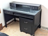 Office desk with glass top and monitor shelf, plus an extra file cabinet. Desk measures 4' x 2' deep