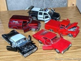 Five 1/24 scale model cars with doors and hoods that open. Many marked Jada Toys on the bottoms.