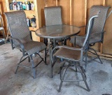 3' diameter glass topped patio table comes with four swiveling stools. All in good condition.