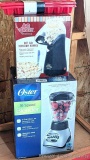Oster 16 speed blender looks to be NIB, Air Crazy popcorn popper, and a pair of ice cube trays.