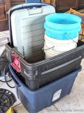 Two totes with lids and a few buckets, largest tote measures 18
