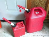 Two gas totes, larger is a 6 gallon, and both have spouts, and the smaller one is almost full of 2
