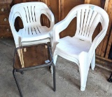 Five resin yard chairs and a little glass topped patio side table.