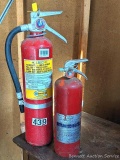 Two General brand fire extinguishers, tallest is 22