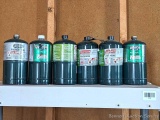 Six Coleman and Worthington propane cylinders.
