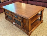 Beautiful coffee table has through-storage and measures 28