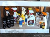 Full and partial bottles of automotive cleaners including leather cleaner, scratch out, tire white,