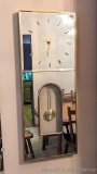 Vintage mirrored wall clock is approx. 3' tall x 15