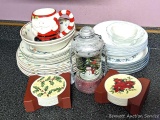 Christmas dishes including plates, a couple of bowls, Santa mug, lantern shaped snow globe,
