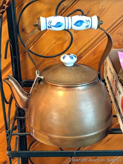 Copper colored tea kettle with ceramic handle and knob in good condition. Measures 9" over handle.
