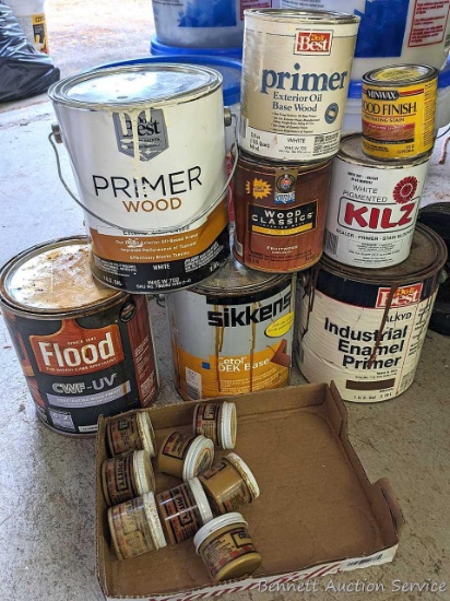 Mostly full and mostly empty containers of Minwax and other wood finish, primers, and putty.