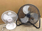Three speed high velocity fan is 2' across; smaller oscillating desk fan stands 1-1/2' high.