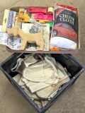 Milk crate half full of nail or raffle aprons; carved wooden dog, and a handful of essentials.