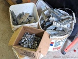 Two buckets of joist hangers and a box of roof deck clips.