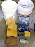 Two five gallon buckets with a couple of grout brushes and a supply of sponges.