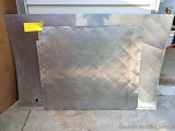 Two sheets of stainless steel, largest is 58