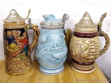 Fishing and other beer stein; plus a musical stein. All around 8-1/2