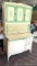 Vintage Hoosier cupboard with flour bin in upper cabinet and pie safe below and enamel counter;