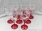 Set of 8 matching stemmed wine glasses with red stems; measures 7-1/2