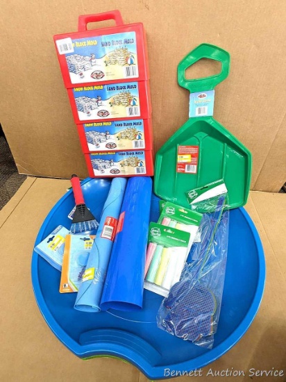 Variety of kids' outdoor activity toys. Different style sleds and saucers, snow / sand block molds,