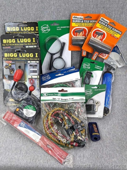Variety of bungee cords, tape measure, padlock with keys, magnifying glass, glass and tile scrapers,