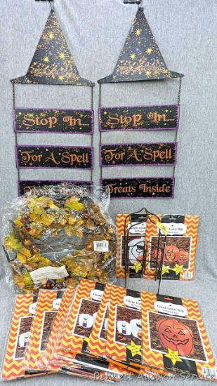 Autumn themed lighted wreath, plethora of giant lawn bags, and small 12" trellis decoration.