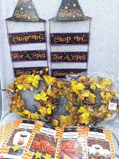 Lighted autumn wreaths, metal Halloween door signs, and variety of giant lawn bags