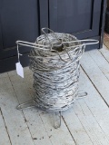 Pickup in Rib Lake. Spool of barbed wire; diameter measurement is 8