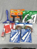 Assortment of home repair tools incl glass and tile scrapers, magnifying glasses, padlock, vinyl