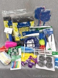 Household supplies incl chargers, cleaning sponges and scrubbers, foldable laundry hamper, hand pump