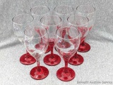Set of 8 matching stemmed wine glasses with red stems; measures 7-1/2