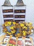 Lighted autumn wreaths, metal Halloween door signs, and variety of giant lawn bags