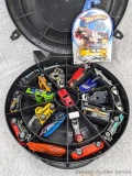 Hot Wheels, Tootsie cars and other metal die-cast cars in a Tire carrying case plus 1 NIP Holiday
